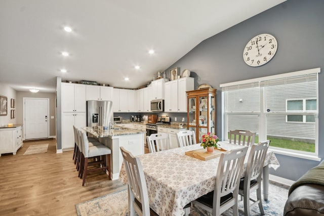7516 Ochoa Ave NE, Otsego, MN 55330 - dining area featuring vaulted ceiling, light wood-style flooring, baseboards, and recessed lighting