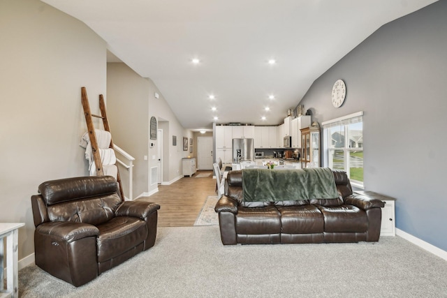 7516 Ochoa Ave NE, Otsego, MN 55330 - living area featuring vaulted ceiling, baseboards, recessed lighting, and light wood-style floors