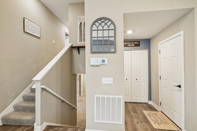 7516 Ochoa Ave NE, Otsego, MN 55330 - foyer entrance featuring wood finished floors, stairway, and baseboards