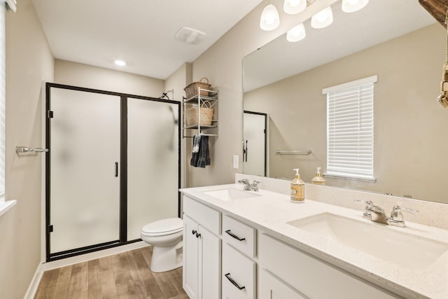 7516 Ochoa Ave NE, Otsego, MN 55330 - full bath featuring a stall shower, toilet, wood finished floors, and double vanity