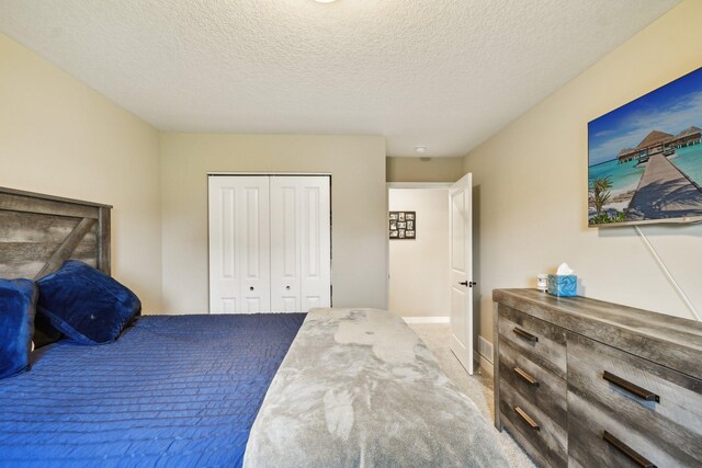 7516 Ochoa Ave NE, Otsego, MN 55330 - bedroom featuring a closet, carpet floors, baseboards, and a textured ceiling