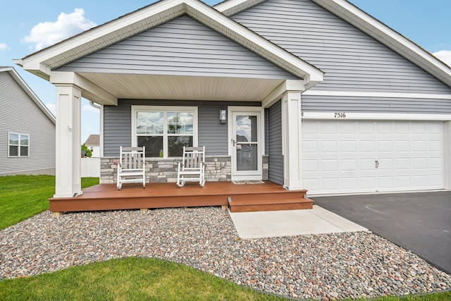 7516 Ochoa Ave NE, Otsego, MN 55330 - view of front of house featuring covered porch, asphalt driveway, and a garage