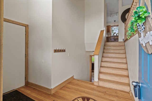 15110 Ute St NW, Ramsey, MN 55303 - staircase featuring wood finished floors and rail lighting
