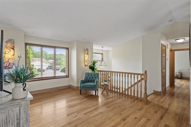 15110 Ute St NW, Ramsey, MN 55303 - sitting room with light wood-style floors, an upstairs landing, and baseboards