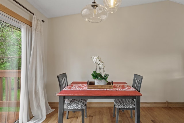 15110 Ute St NW, Ramsey, MN 55303 - dining area featuring a chandelier, light wood finished floors, and baseboards