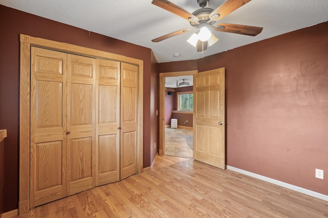 15110 Ute St NW, Ramsey, MN 55303 - unfurnished bedroom with baseboards, light wood-style flooring, a closet, and ceiling fan