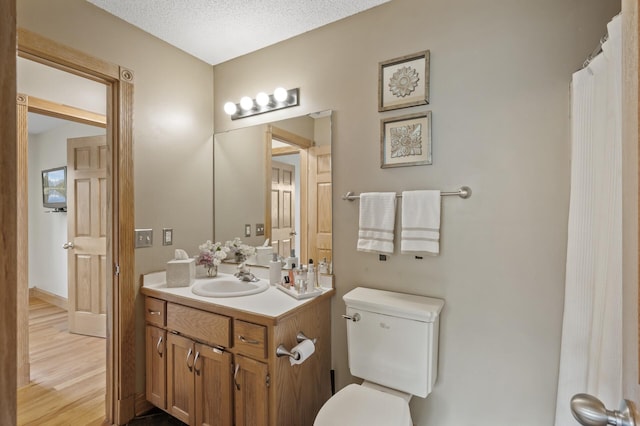 15110 Ute St NW, Ramsey, MN 55303 - bathroom with vanity, toilet, and wood finished floors