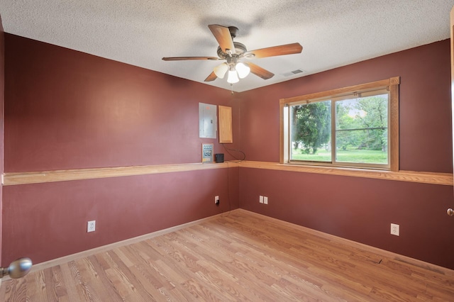 15110 Ute St NW, Ramsey, MN 55303 - empty room featuring wood finished floors, a textured ceiling, ceiling fan, electric panel, and baseboards