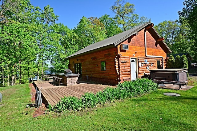 17377 Paradise Shores Rd, Maple Grove Twp, MN 56401 - view of side of home with a hot tub, a deck, a yard, and log exterior