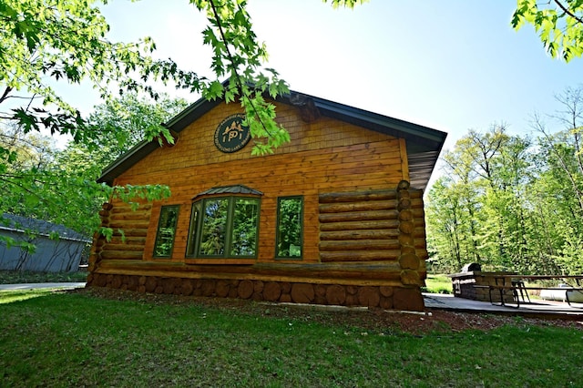 17377 Paradise Shores Rd, Maple Grove Twp, MN 56401 - view of side of home featuring log siding and a lawn