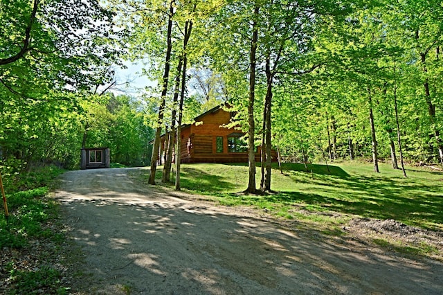 17377 Paradise Shores Rd, Maple Grove Twp, MN 56401 - view of side of home with a lawn, a view of trees, and driveway