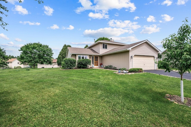 3649 Tower Pond Dr, Anoka, MN 55303 - view of front of property with a garage, asphalt driveway, a front yard, and a chimney
