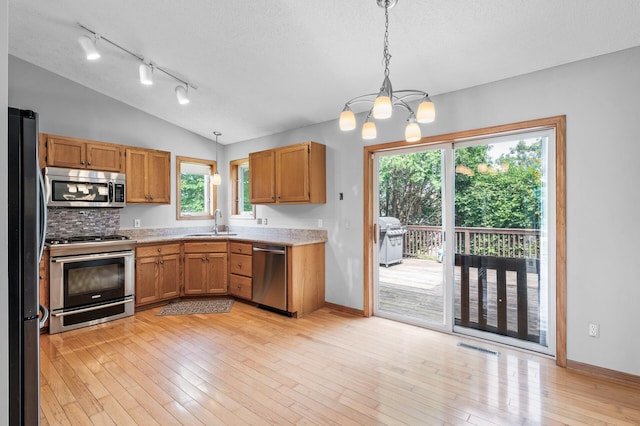 3649 Tower Pond Dr, Anoka, MN 55303 - kitchen featuring stainless steel appliances, light countertops, a chandelier, healthy amount of natural light, and lofted ceiling