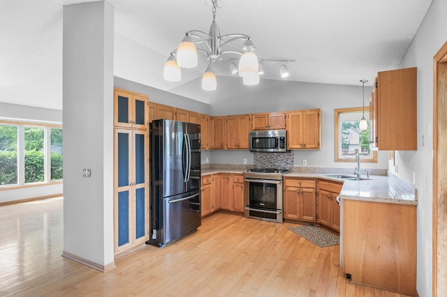 3649 Tower Pond Dr, Anoka, MN 55303 - kitchen with stainless steel appliances, vaulted ceiling, light wood-style flooring, a chandelier, and light countertops