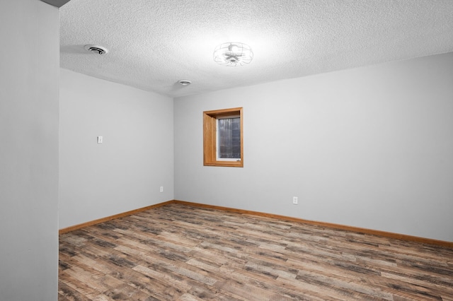 3649 Tower Pond Dr, Anoka, MN 55303 - spare room with wood finished floors and a textured ceiling
