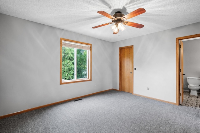 3649 Tower Pond Dr, Anoka, MN 55303 - unfurnished bedroom with carpet, a textured ceiling, ensuite bath, and ceiling fan