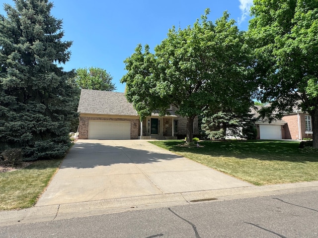13638 43rd St NE, Saint Michael, MN 55376 - obstructed view of property with an attached garage, a front lawn, driveway, and brick siding