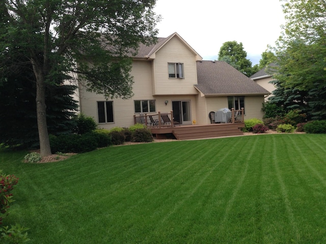 13638 43rd St NE, Saint Michael, MN 55376 - rear view of house featuring a deck, a yard, and roof with shingles