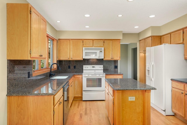 13638 43rd St NE, Saint Michael, MN 55376 - kitchen with white appliances, light wood finished floors, a kitchen island, dark stone countertops, and backsplash