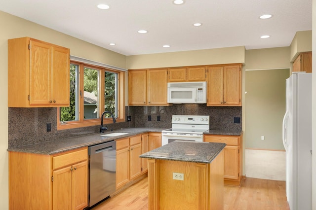 13638 43rd St NE, Saint Michael, MN 55376 - kitchen with white appliances, light wood-type flooring, a kitchen island, recessed lighting, and dark stone counters