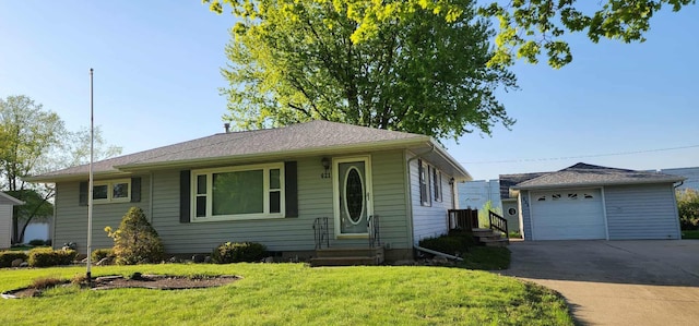 621 16th St, Albert Lea, MN 56007 - single story home with a detached garage, entry steps, a front yard, driveway, and an outbuilding