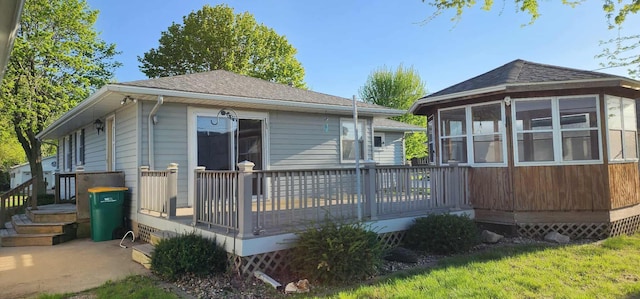 621 16th St, Albert Lea, MN 56007 - rear view of property with a deck, a sunroom, and a shingled roof