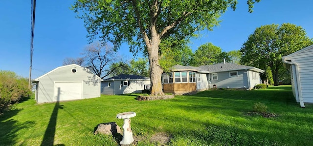 621 16th St, Albert Lea, MN 56007 - view of green lawn featuring a detached garage, an outbuilding, and a sunroom