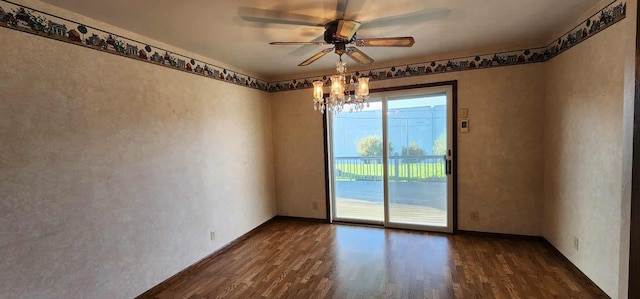 621 16th St, Albert Lea, MN 56007 - unfurnished room with dark wood-type flooring, a ceiling fan, a chandelier, and baseboards