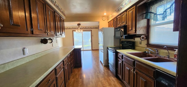 621 16th St, Albert Lea, MN 56007 - kitchen featuring black appliances, a sink, a ceiling fan, light countertops, and light wood finished floors