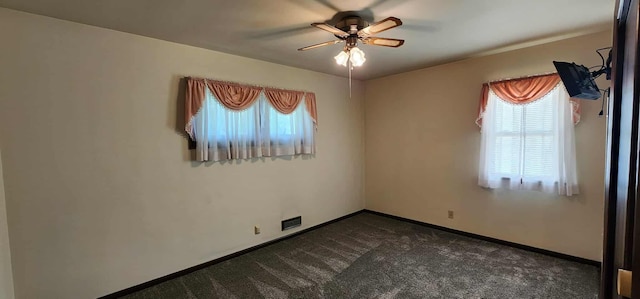 621 16th St, Albert Lea, MN 56007 - spare room with a ceiling fan, dark colored carpet, and baseboards