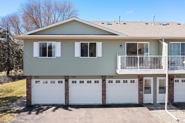 1030 Pond View Ct, Vadnais Heights, MN 55127 - view of front of home with brick siding, a garage, a balcony, and driveway