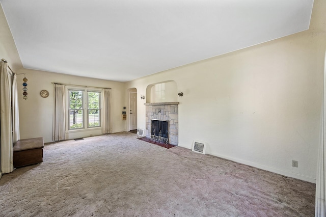 unfurnished living room featuring a fireplace, carpet flooring, and baseboards