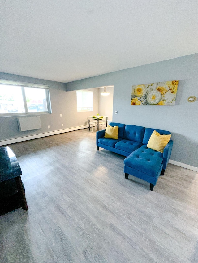 4407 Wilshire Blvd Unit 110, Mound, MN 55364 - living room with wood finished floors, baseboards, and a baseboard heating unit