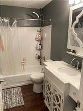 3422 Highlander Dr, Eagan, MN 55122 - full bathroom with toilet, vanity, shower / bathtub combination with curtain, and wood finished floors