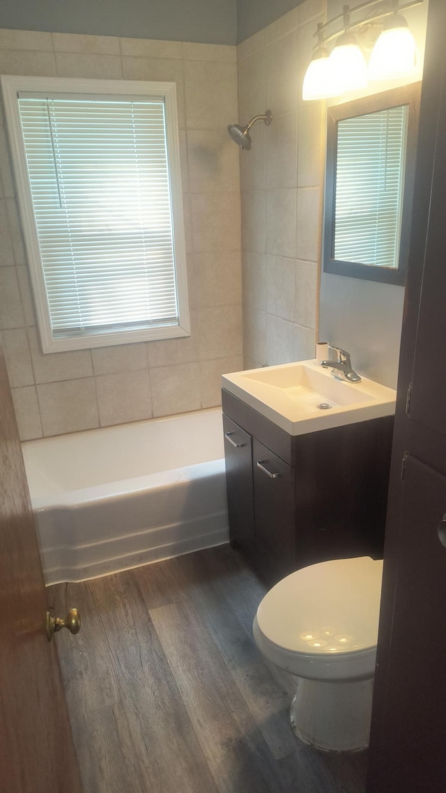 1339 Payne Ave, Saint Paul, MN 55101 - full bathroom with vanity, wood finished floors, tub / shower combination, and toilet