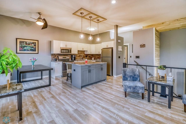 2814 26th Street Cir S, Moorhead, MN 56560 - kitchen with appliances with stainless steel finishes, a sink, white cabinets, tasteful backsplash, and a kitchen island