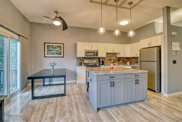 2814 26th Street Cir S, Moorhead, MN 56560 - kitchen featuring stainless steel appliances, ceiling fan, baseboards, decorative backsplash, and light wood finished floors