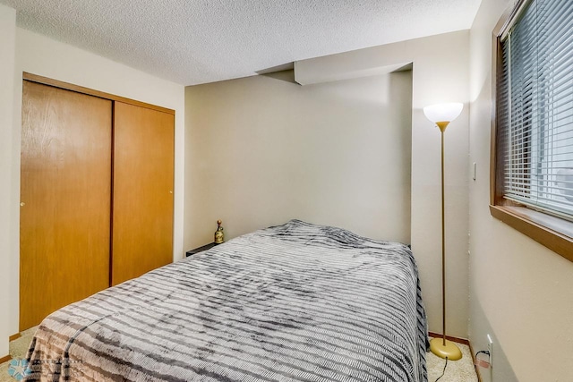 2814 26th Street Cir S, Moorhead, MN 56560 - bedroom with a closet, a textured ceiling, and light colored carpet