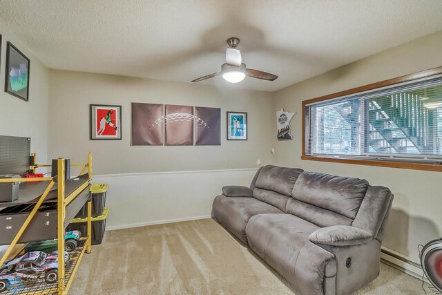 2814 26th Street Cir S, Moorhead, MN 56560 - carpeted living area with ceiling fan, a baseboard radiator, and a textured ceiling