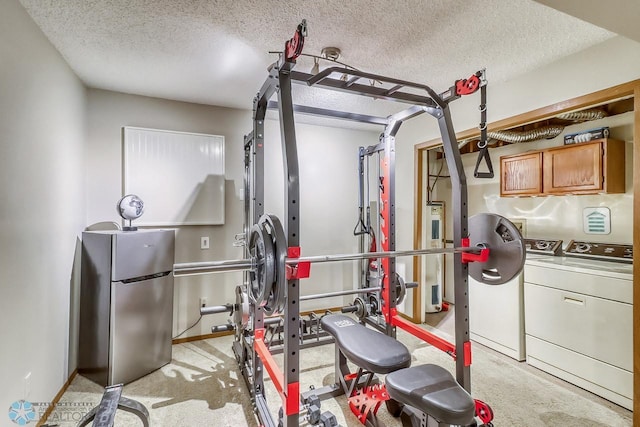 2814 26th Street Cir S, Moorhead, MN 56560 - workout area featuring separate washer and dryer, a textured ceiling, electric water heater, and baseboards