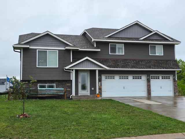 view of front of home with driveway, a front yard, a garage, and stone siding