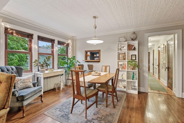 285 Cliff St Unit 4, Saint Paul, MN 55102 - dining space featuring crown molding, hardwood / wood-style flooring, radiator, and an ornate ceiling
