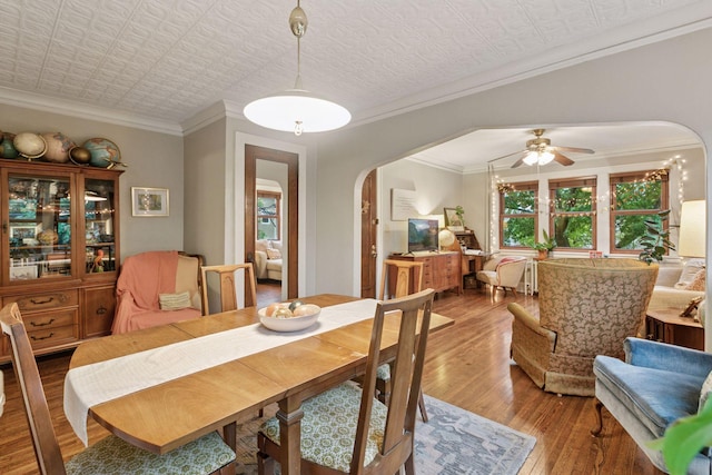 285 Cliff St Unit 4, Saint Paul, MN 55102 - dining area with arched walkways, an ornate ceiling, ornamental molding, a ceiling fan, and hardwood / wood-style flooring