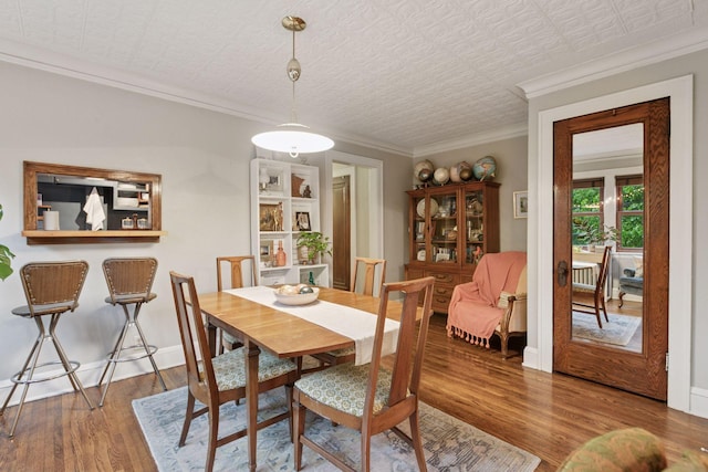 285 Cliff St Unit 4, Saint Paul, MN 55102 - dining space with wood finished floors, crown molding, an ornate ceiling, and baseboards