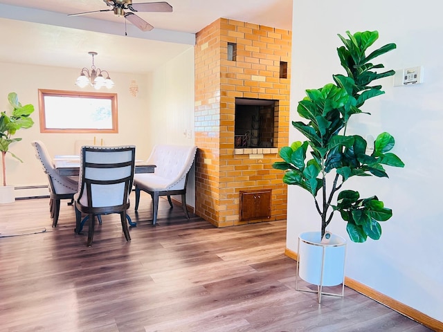 5117 Clear Spring Rd, Minnetonka, MN 55345 - dining space with a baseboard heating unit, wood finished floors, baseboards, a ceiling fan, and a chandelier