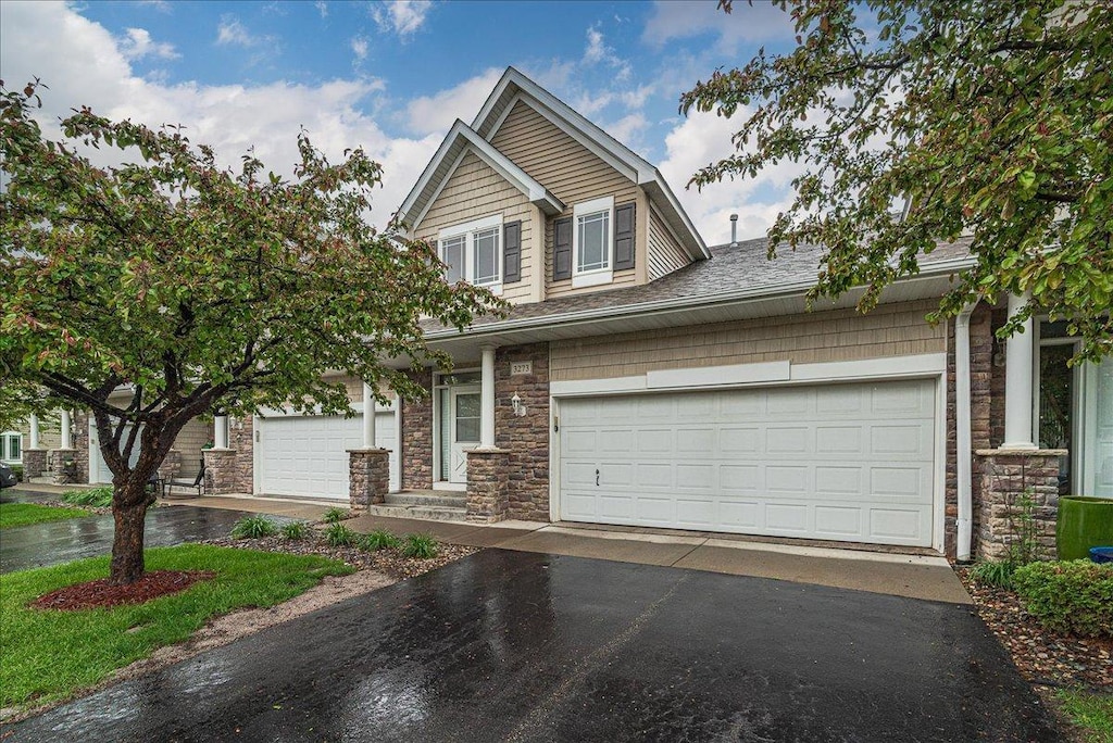 3273 136th St W, Rosemount, MN 55068 - view of front facade featuring asphalt driveway, stone siding, and a garage