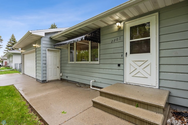 2207 16th St S, Fargo, ND 58103 - view of exterior entry featuring a garage