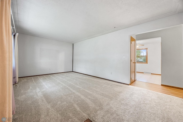 2207 16th St S, Fargo, ND 58103 - carpeted empty room featuring baseboards, a textured ceiling, and crown molding