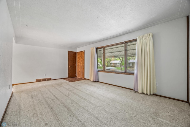2207 16th St S, Fargo, ND 58103 - carpeted empty room with a textured ceiling and baseboards