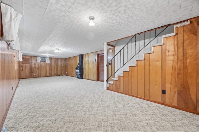 2207 16th St S, Fargo, ND 58103 - below grade area featuring wooden walls, stairway, carpet floors, and baseboards